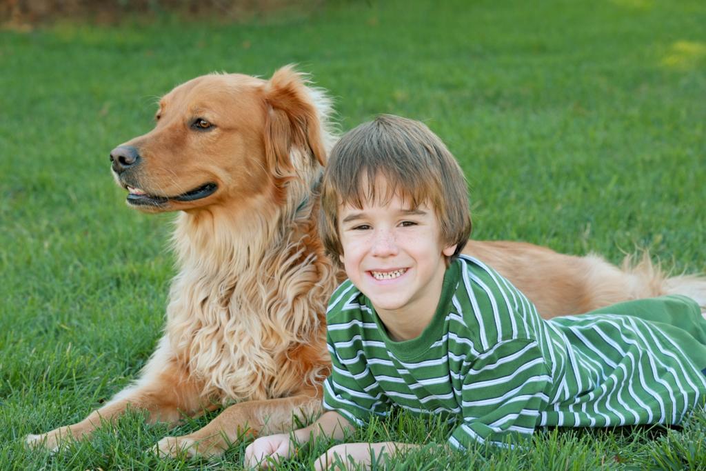 Boy Laying Down With Dog